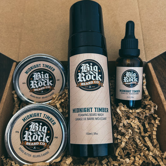 Big Rock Beard Co. grooming products including a bottle, two tins, and a dropper in a cardboard box.